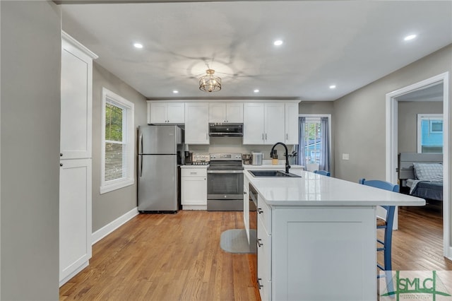 kitchen with a healthy amount of sunlight, sink, white cabinetry, and stainless steel appliances