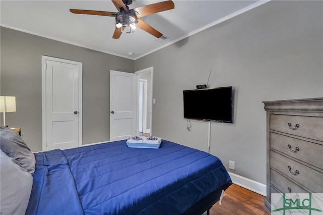 bedroom with ceiling fan, dark wood-type flooring, and ornamental molding