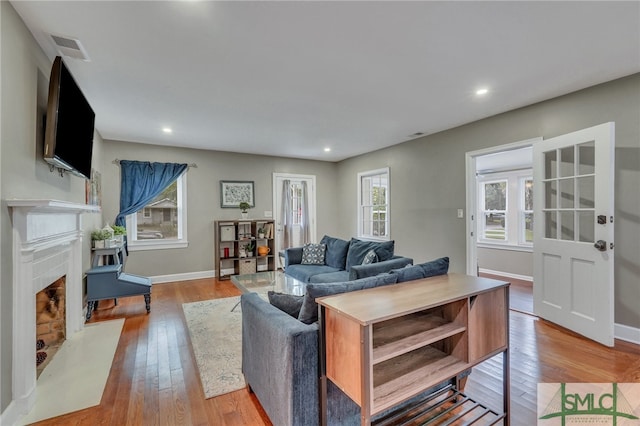 living room featuring light hardwood / wood-style flooring and plenty of natural light