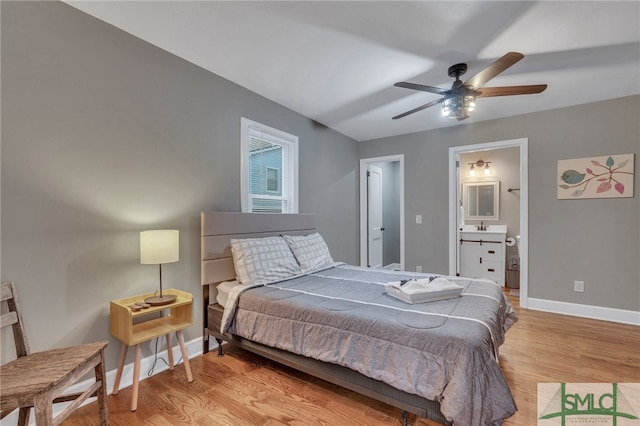 bedroom with ensuite bathroom, ceiling fan, light hardwood / wood-style floors, and sink