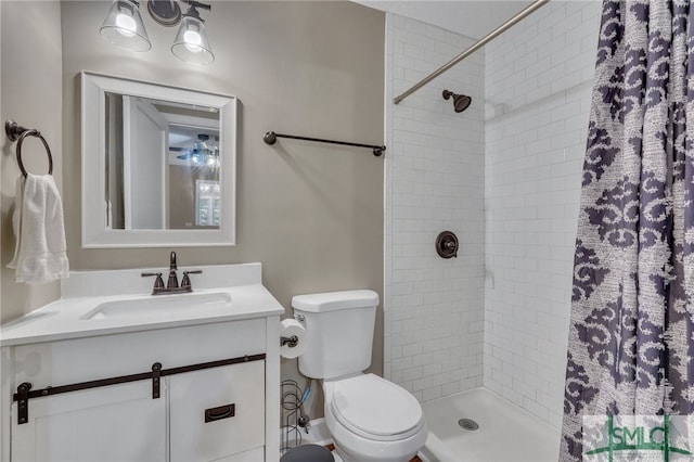 bathroom featuring vanity, toilet, and walk in shower