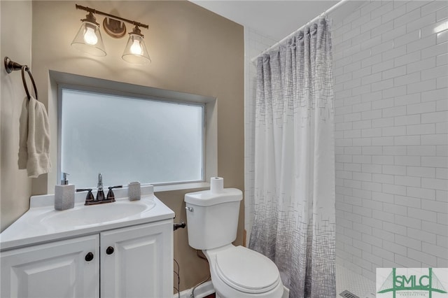 bathroom with vanity, toilet, and walk in shower