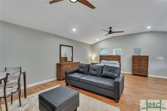 living room with light wood-type flooring and vaulted ceiling