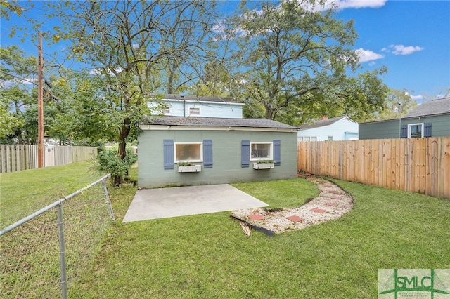 rear view of house with a patio area and a lawn