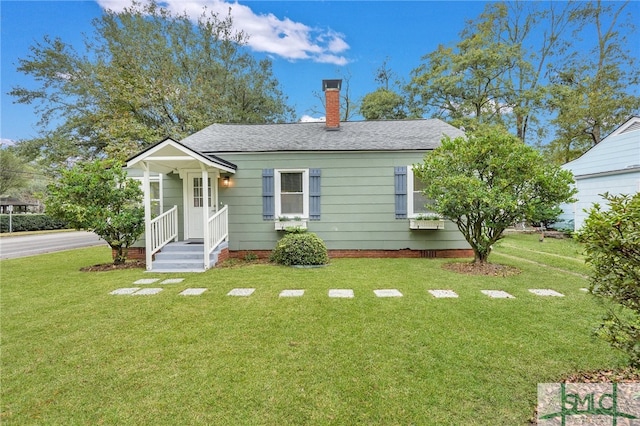 bungalow-style home with a front yard