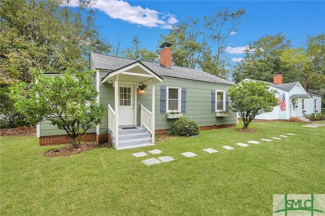 bungalow-style house featuring a front yard