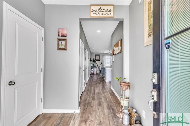 hallway with hardwood / wood-style floors