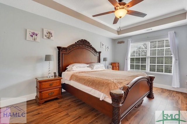 126 Thornbush Ct NE, Ludowici, GA 31316 - bedroom featuring ceiling fan, dark hardwood / wood-style flooring, crown molding, and a tray ceiling