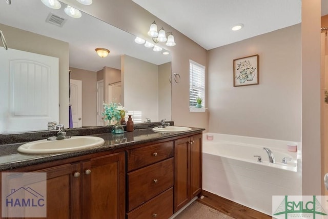 126 Thornbush Ct NE, Ludowici, GA 31316 - bathroom featuring vanity, wood-type flooring, and independent shower and bath