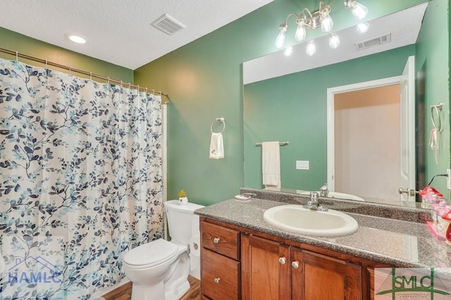 126 Thornbush Ct NE, Ludowici, GA 31316 - bathroom with a textured ceiling, toilet, vanity, and walk in shower