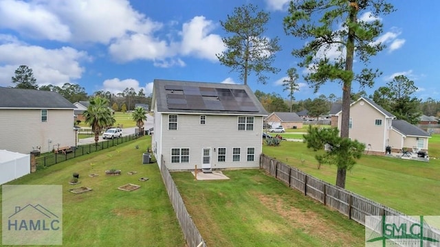 126 Thornbush Ct NE, Ludowici, GA 31316 - rear view of property with central AC unit, a patio area, solar panels, and a yard
