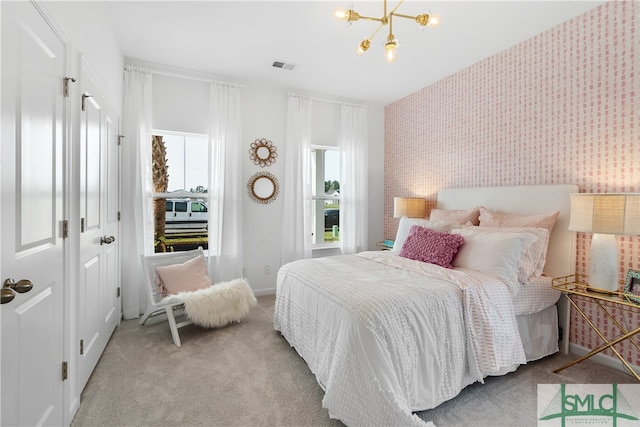 bedroom with wallpapered walls, multiple windows, visible vents, and light colored carpet