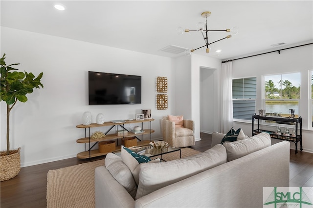 living room featuring baseboards, wood finished floors, and recessed lighting