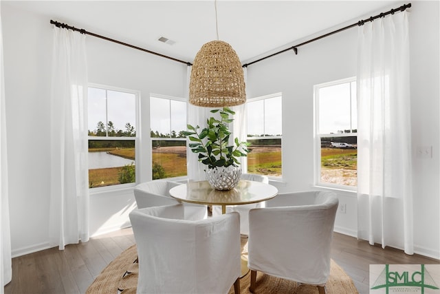 dining room featuring wood-type flooring and visible vents