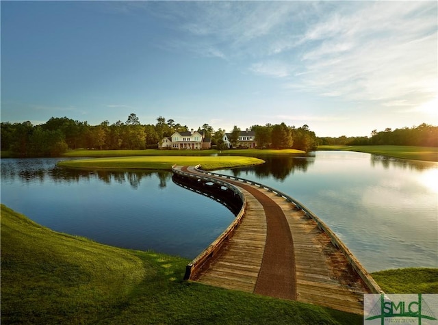 view of community featuring a water view and a yard