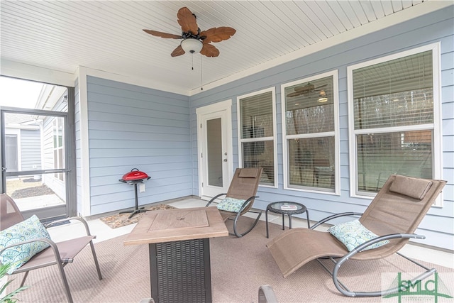 view of patio / terrace featuring ceiling fan and an outdoor fire pit