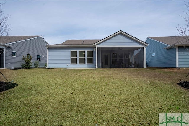 back of house featuring a lawn and a sunroom