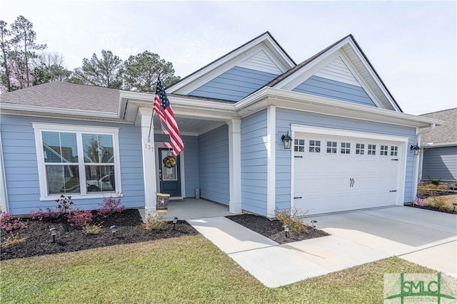 view of front of property with a garage and a front lawn