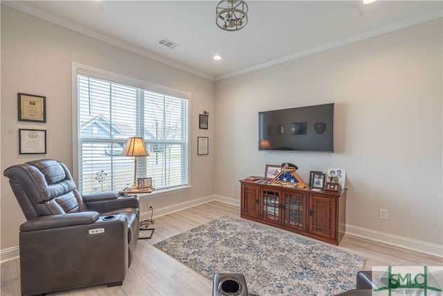 sitting room with crown molding, plenty of natural light, and light hardwood / wood-style flooring