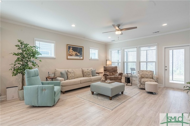 living room featuring crown molding, light hardwood / wood-style floors, and ceiling fan