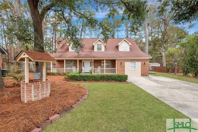 cape cod-style house featuring covered porch, central AC unit, and a front lawn