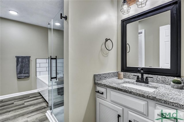 bathroom with vanity, separate shower and tub, and wood-type flooring