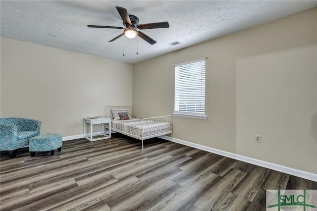 bedroom featuring a textured ceiling, hardwood / wood-style flooring, and ceiling fan