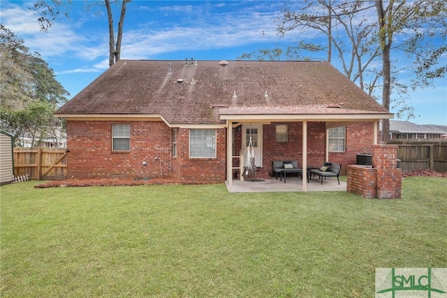 back of property with a yard and a patio