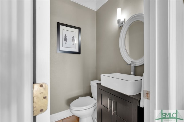 bathroom with tile patterned flooring, vanity, and toilet