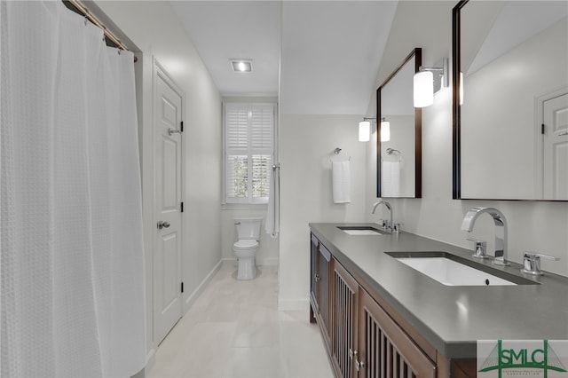 bathroom with tile patterned floors, vanity, and toilet