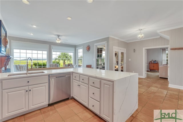 kitchen featuring ceiling fan, crown molding, sink, dishwasher, and white cabinetry