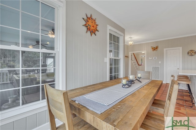 dining space with hardwood / wood-style floors and ornamental molding