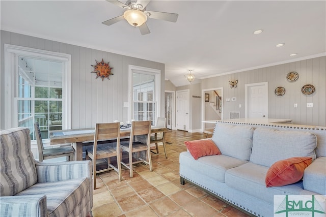 living room with ceiling fan and crown molding