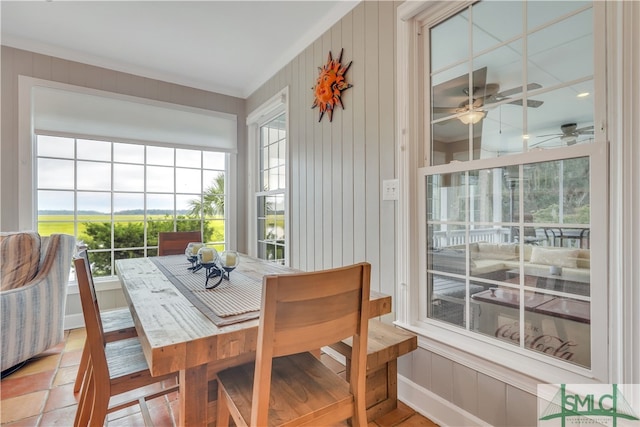 sunroom / solarium featuring ceiling fan and a healthy amount of sunlight