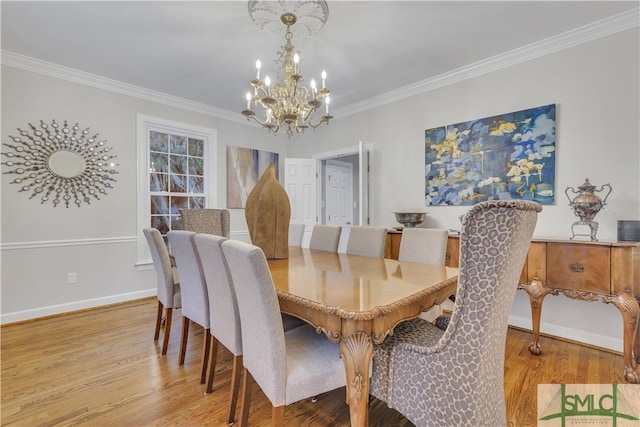 dining area with an inviting chandelier, crown molding, and light hardwood / wood-style flooring