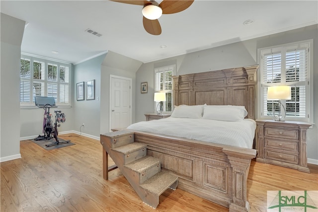 bedroom with ceiling fan, ornamental molding, and light hardwood / wood-style flooring