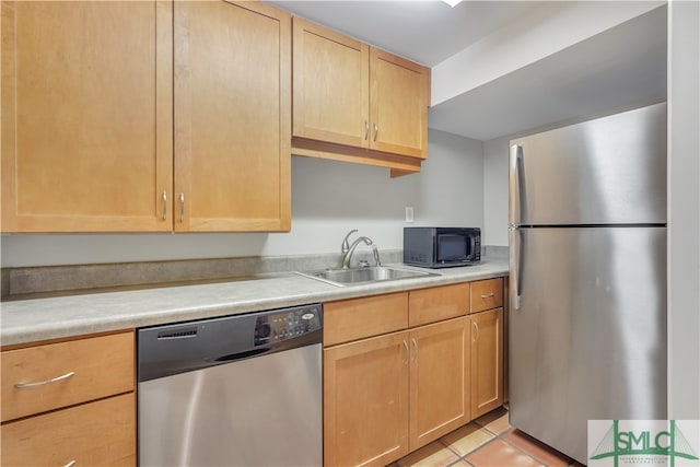 kitchen featuring sink, light tile patterned floors, stainless steel appliances, and light brown cabinetry