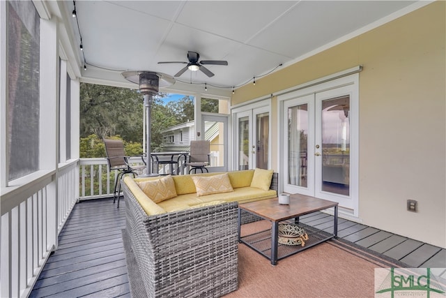 sunroom / solarium featuring ceiling fan and french doors