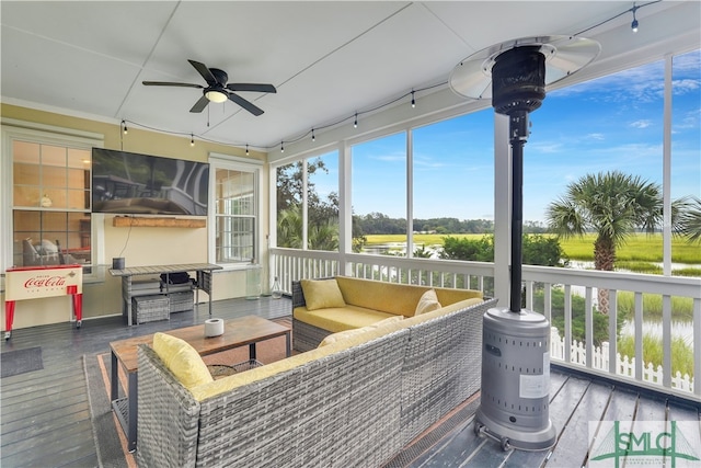 sunroom featuring ceiling fan