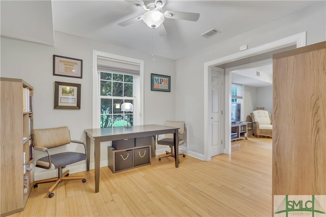 home office with ceiling fan and light hardwood / wood-style flooring