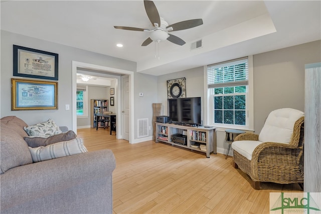 living room with ceiling fan and wood-type flooring