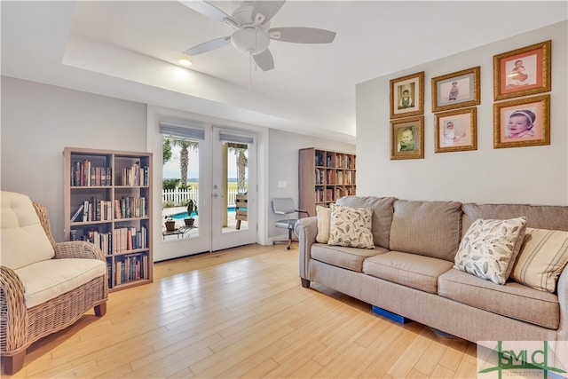 living room with ceiling fan and light wood-type flooring