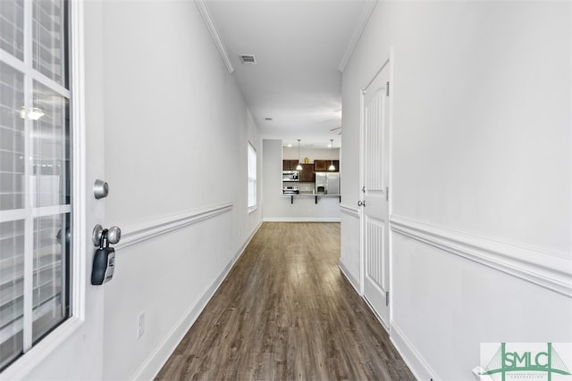 corridor featuring dark hardwood / wood-style floors and ornamental molding