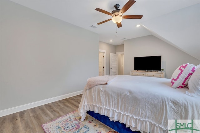 bedroom featuring light hardwood / wood-style floors, ceiling fan, and lofted ceiling