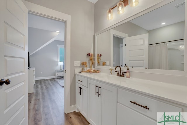 bathroom featuring hardwood / wood-style floors, vanity, and a shower with curtain