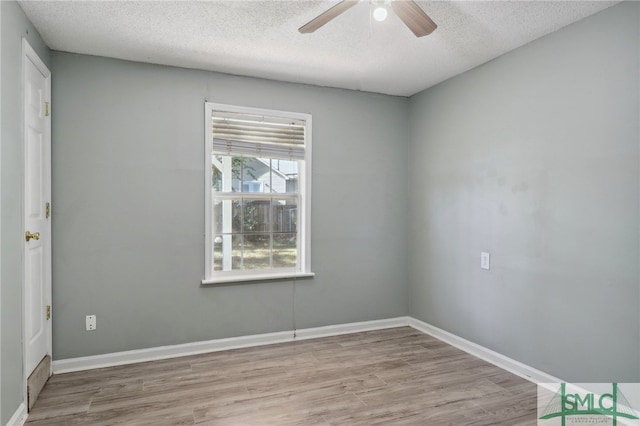 spare room with ceiling fan, light hardwood / wood-style flooring, and a textured ceiling