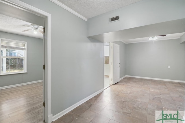 interior space featuring crown molding, ceiling fan, and a textured ceiling