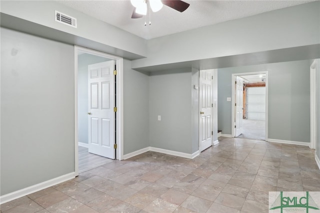 spare room featuring ceiling fan and a textured ceiling