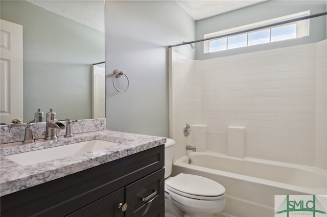 full bathroom with shower / tub combination, vanity, a textured ceiling, and toilet