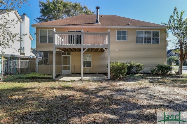 rear view of property with a sunroom and a deck